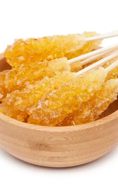 Saffron-candy-with-wooden-handle-in-a-wooden-bowl